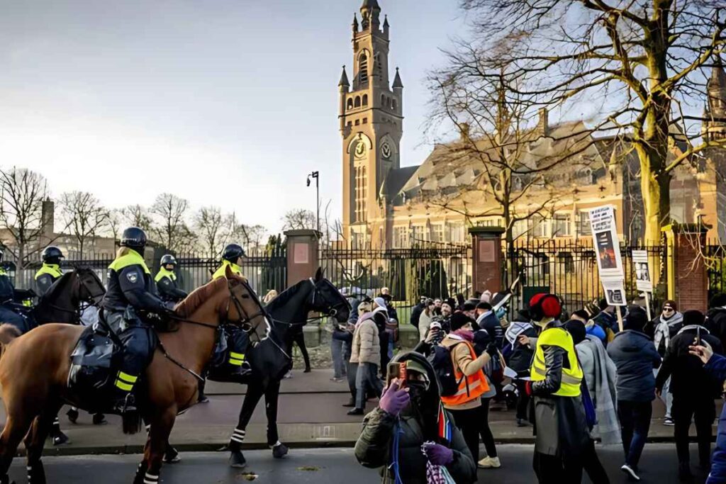 Police clear protesters outside The Hague's ICJ on Thursday.